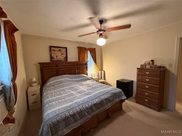 bedroom featuring a ceiling fan and light colored carpet