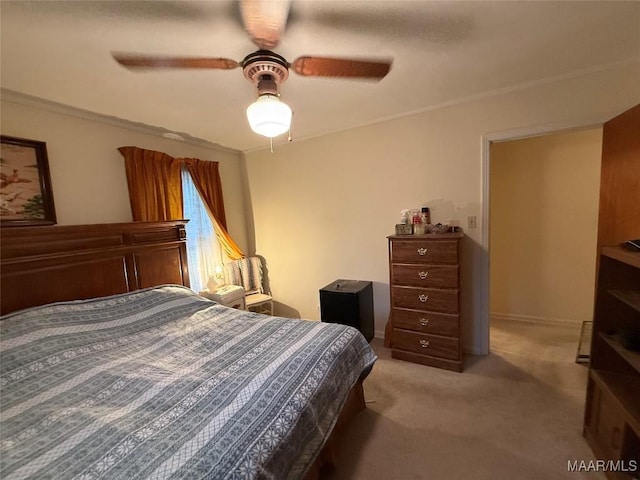 bedroom featuring ceiling fan, baseboards, and light colored carpet