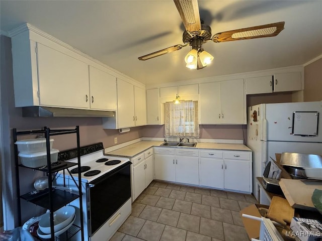 kitchen with range with electric stovetop, a sink, white cabinets, light countertops, and freestanding refrigerator