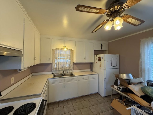 kitchen featuring freestanding refrigerator, light countertops, a sink, and under cabinet range hood