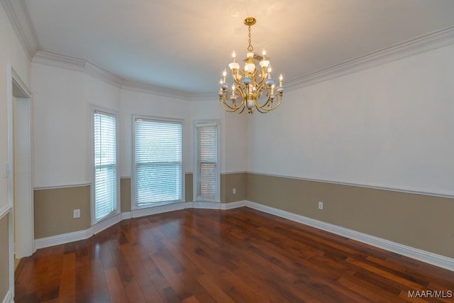 unfurnished room featuring an inviting chandelier, baseboards, ornamental molding, and wood finished floors