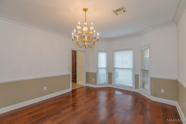 spare room featuring ornamental molding, visible vents, and wood finished floors