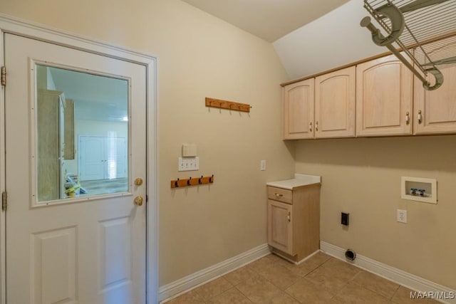 laundry area featuring washer hookup, cabinet space, hookup for an electric dryer, light tile patterned flooring, and baseboards