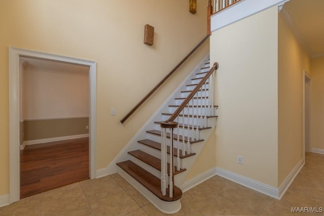 stairs with baseboards and tile patterned floors