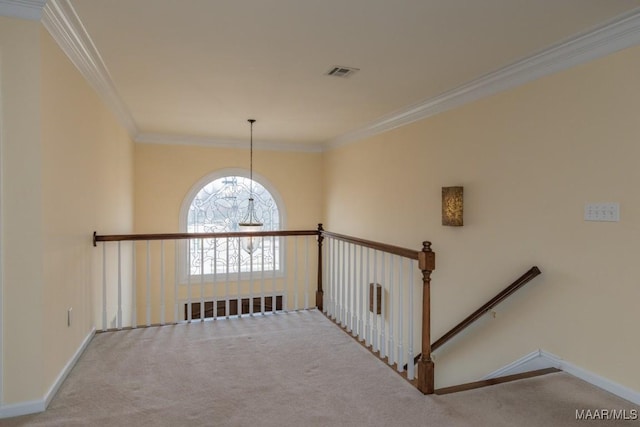 hallway featuring carpet, visible vents, baseboards, and ornamental molding