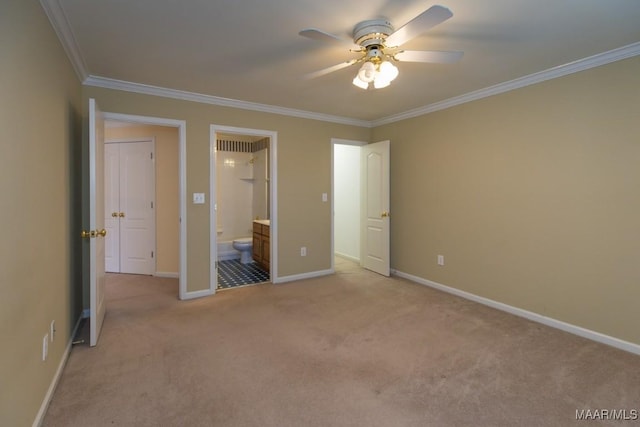 unfurnished bedroom featuring ornamental molding, light carpet, baseboards, and ensuite bathroom