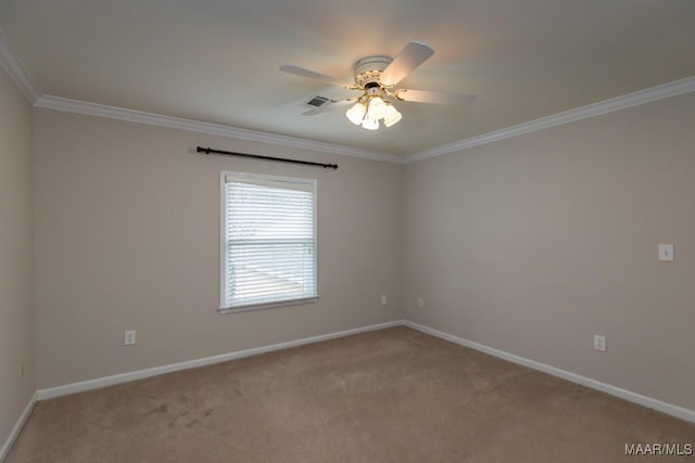 carpeted empty room featuring visible vents, crown molding, baseboards, and ceiling fan