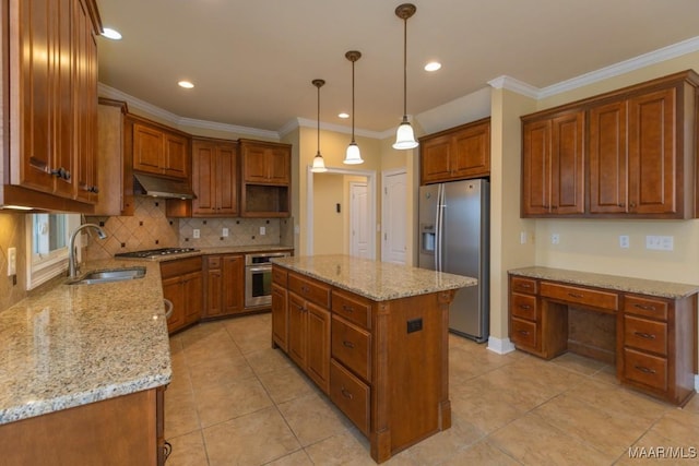 kitchen featuring appliances with stainless steel finishes, brown cabinetry, a sink, and built in study area