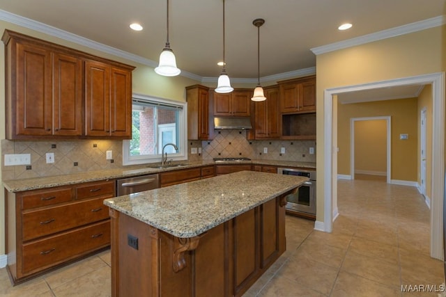 kitchen featuring brown cabinets, appliances with stainless steel finishes, ornamental molding, a sink, and under cabinet range hood