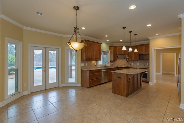 kitchen featuring french doors, brown cabinets, tasteful backsplash, stainless steel dishwasher, and under cabinet range hood