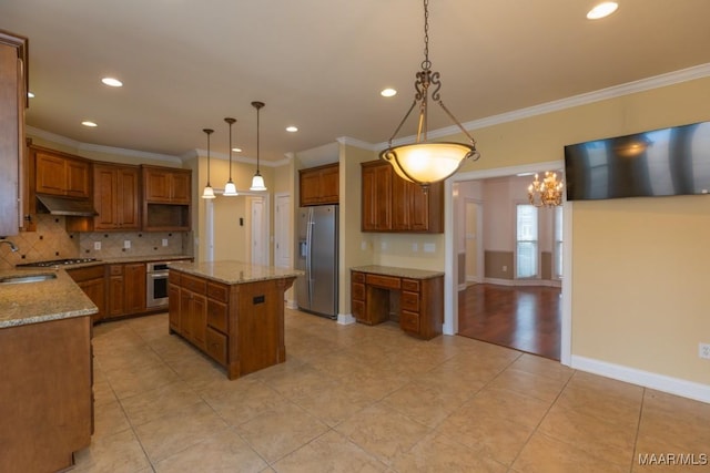 kitchen featuring stainless steel appliances, brown cabinets, under cabinet range hood, and tasteful backsplash