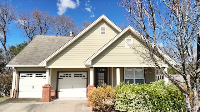 view of front of house with brick siding, an attached garage, concrete driveway, and a shingled roof