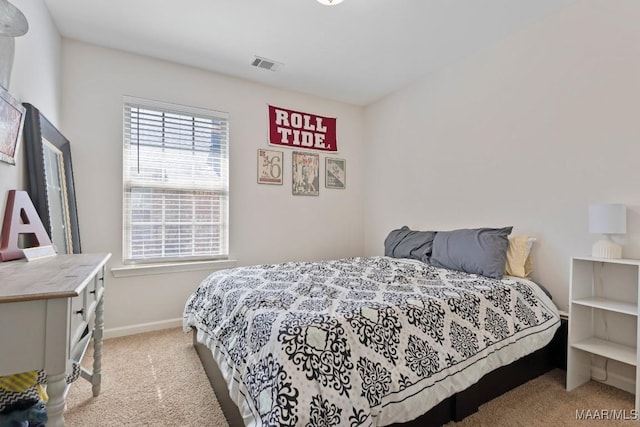 carpeted bedroom featuring baseboards and visible vents