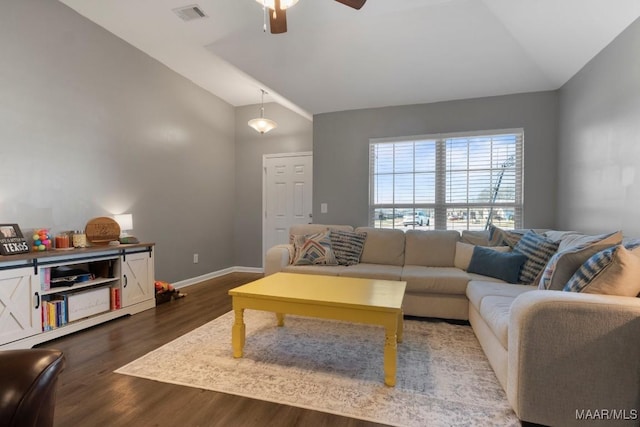 living room with lofted ceiling, dark wood-style flooring, and visible vents