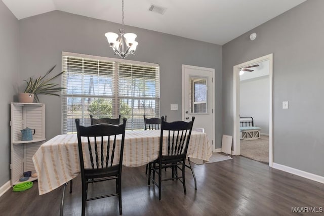 dining room with dark wood finished floors, lofted ceiling, visible vents, an inviting chandelier, and baseboards