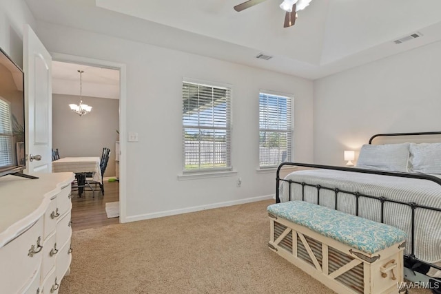 bedroom with visible vents, light carpet, and baseboards