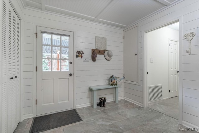 interior space featuring visible vents and wooden walls