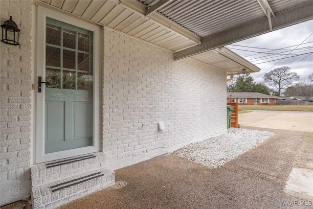 doorway to property with brick siding