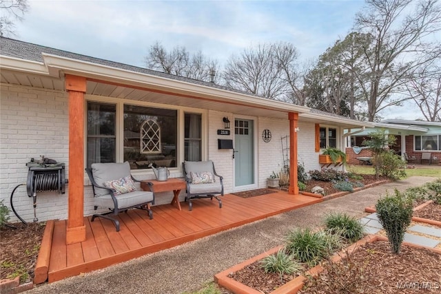 exterior space with covered porch and brick siding