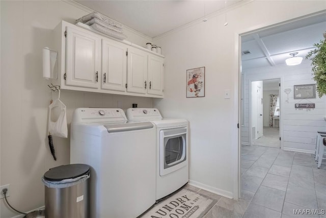 clothes washing area with separate washer and dryer, visible vents, baseboards, cabinet space, and crown molding