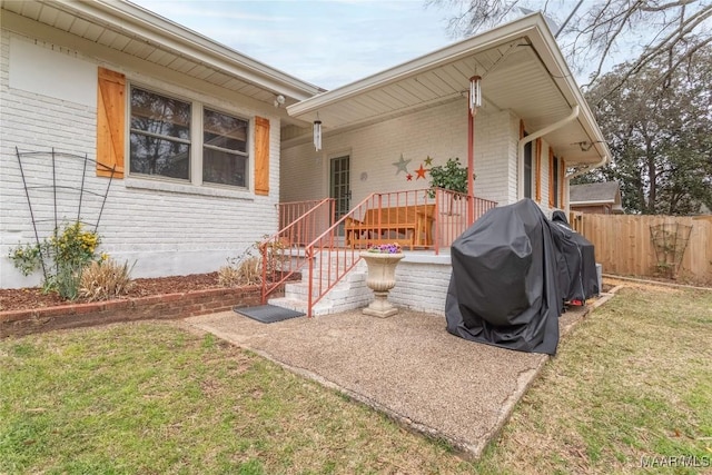 exterior space with fence and brick siding