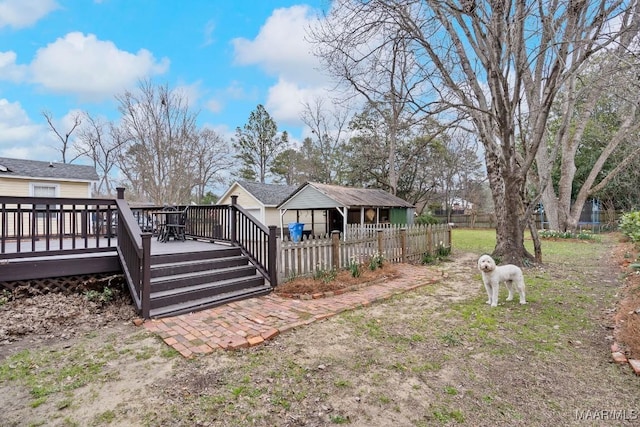 view of yard featuring fence and a wooden deck