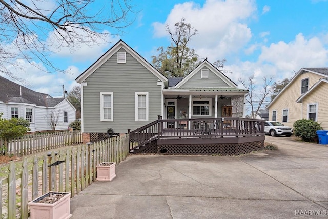 rear view of property with a porch and fence