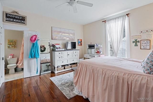 bedroom featuring a ceiling fan, dark wood-style flooring, and ensuite bathroom