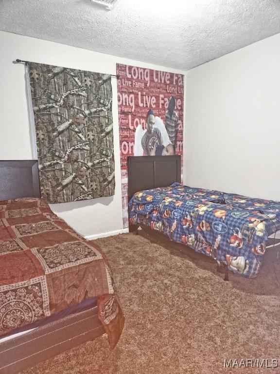 bedroom with carpet flooring and a textured ceiling