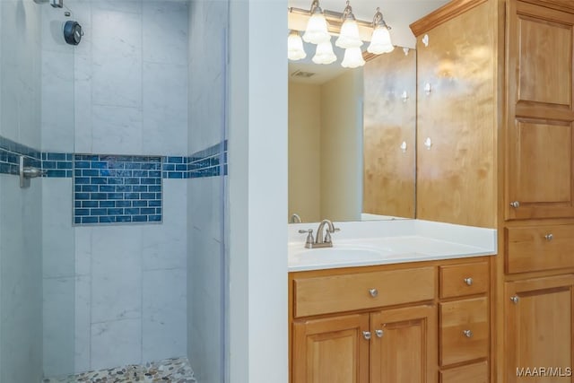 bathroom with visible vents, a shower stall, and vanity