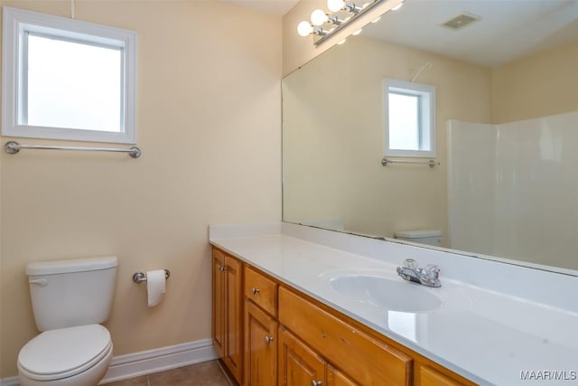 bathroom with visible vents, toilet, vanity, tile patterned flooring, and baseboards