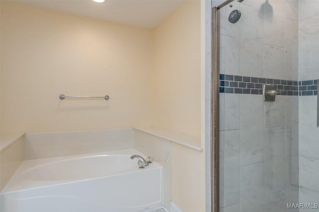 bathroom featuring tiled shower and a garden tub