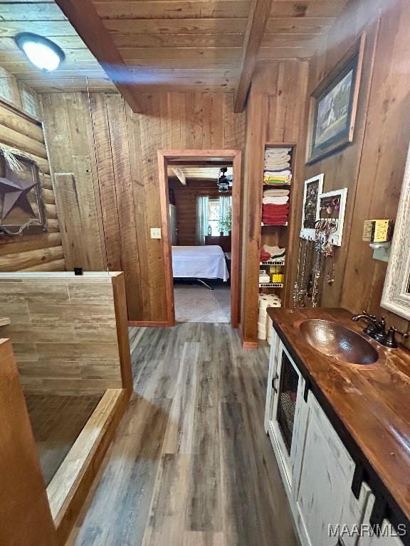 bathroom featuring vanity, beamed ceiling, wood finished floors, and wood ceiling