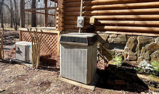 exterior details featuring electric meter, ac unit, log siding, and central AC