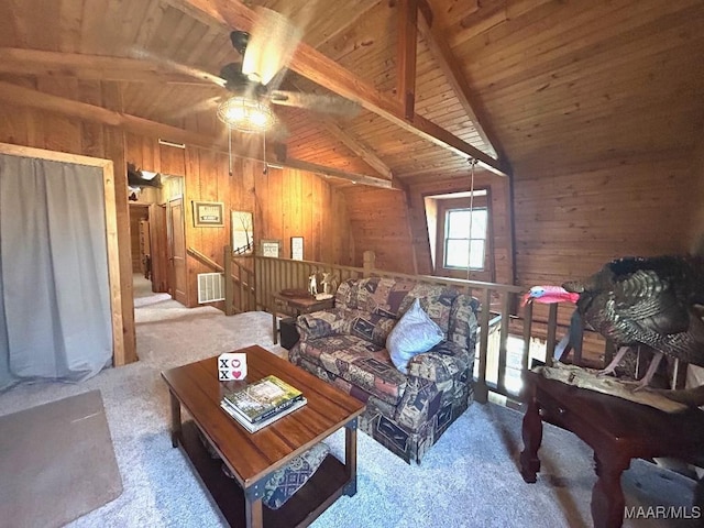 carpeted living room with wooden walls, visible vents, a ceiling fan, lofted ceiling with beams, and wood ceiling