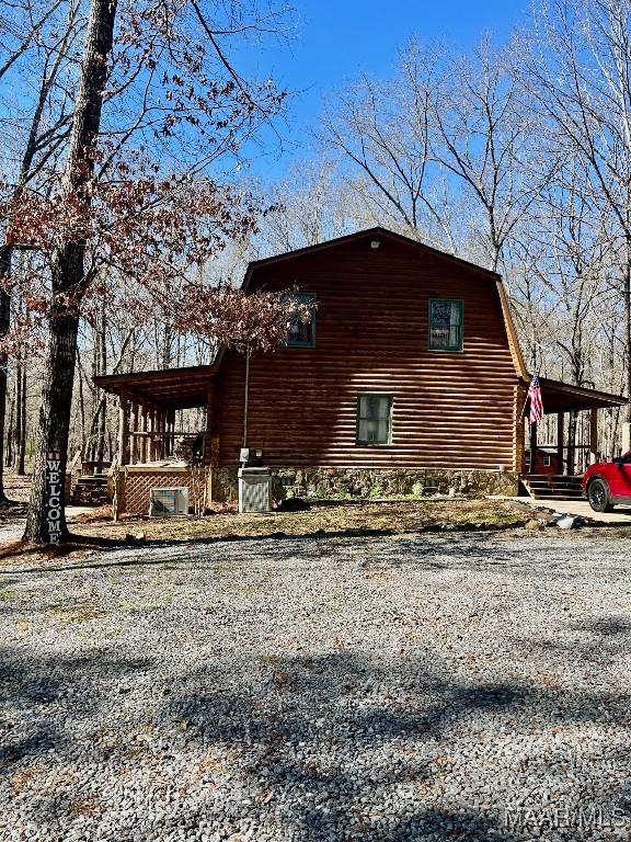 view of side of property featuring a gambrel roof