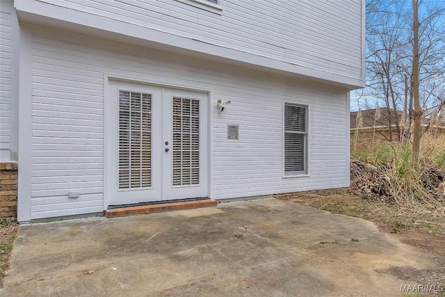 view of exterior entry with a patio