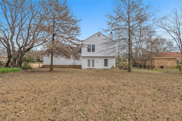 rear view of house featuring a yard, french doors, and crawl space