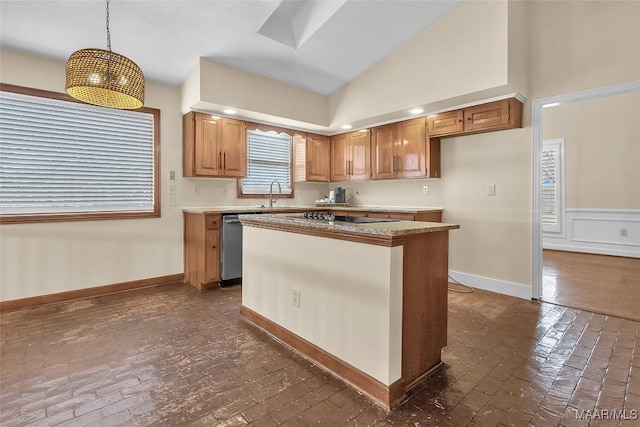 kitchen with brick floor, a center island, lofted ceiling with skylight, a sink, and baseboards