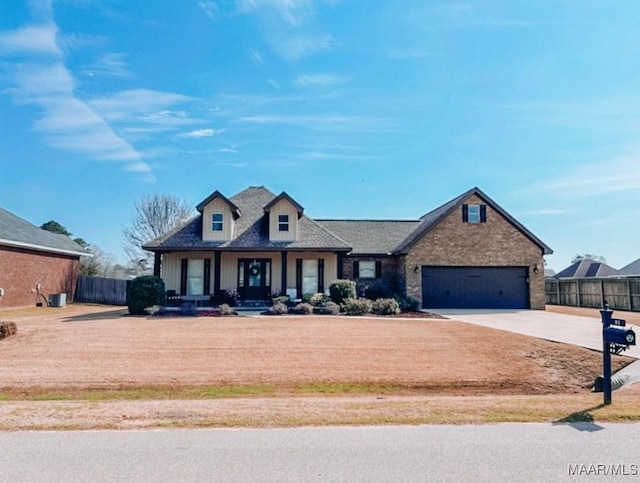 view of front of property featuring a garage, fence, and driveway