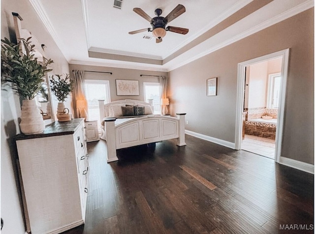 bedroom featuring visible vents, baseboards, dark wood-style floors, a tray ceiling, and crown molding