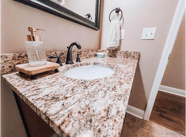 bathroom with baseboards and vanity