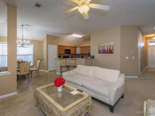 living room featuring baseboards, visible vents, and vaulted ceiling