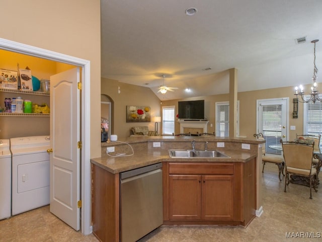 kitchen with a sink, visible vents, open floor plan, stainless steel dishwasher, and washer and clothes dryer