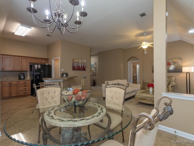 dining room featuring baseboards, visible vents, arched walkways, vaulted ceiling, and ceiling fan with notable chandelier