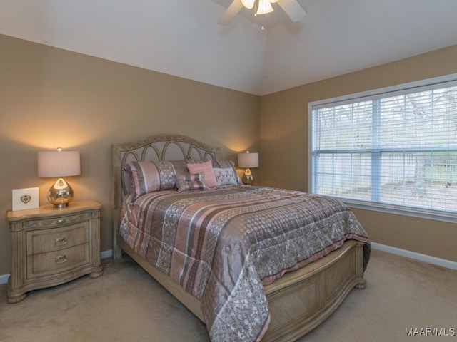 bedroom with light carpet, ceiling fan, vaulted ceiling, and baseboards