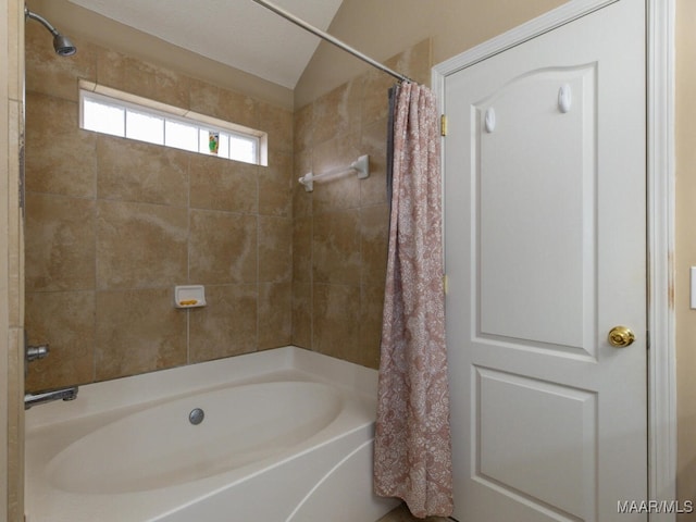 full bath featuring vaulted ceiling and shower / bathtub combination with curtain