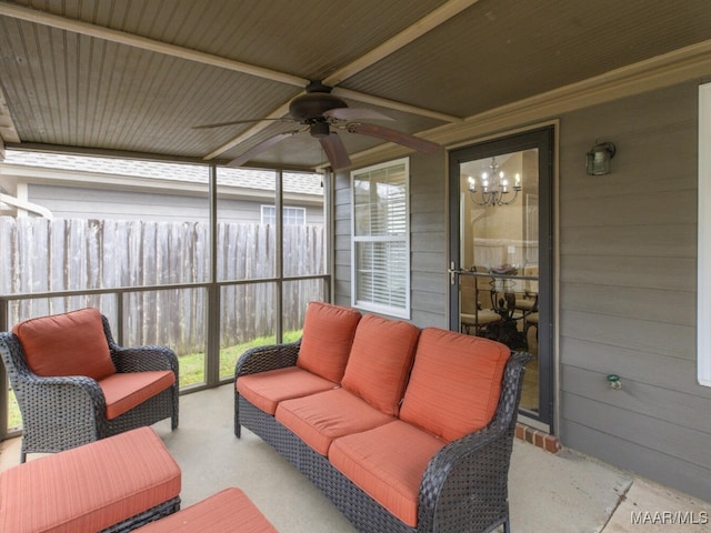 sunroom with ceiling fan with notable chandelier