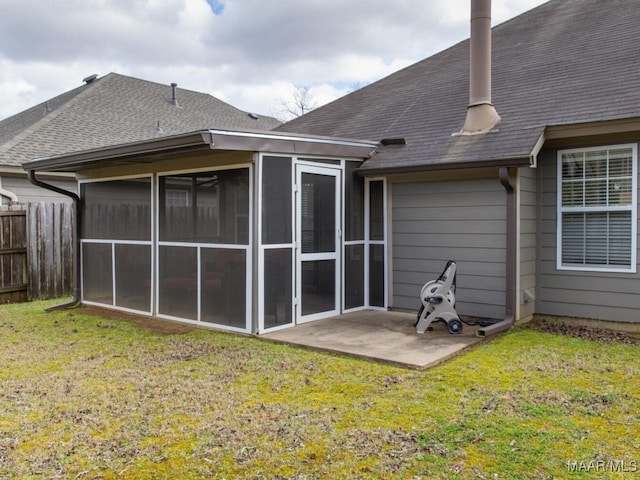 back of house with a yard, a shingled roof, and fence