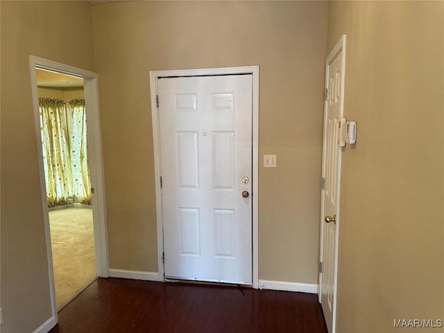 entryway with baseboards and wood finished floors